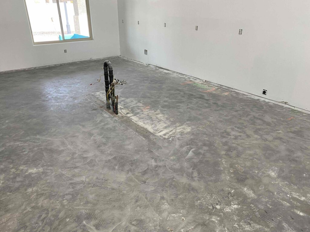 scarified concrete subfloor after tile removal